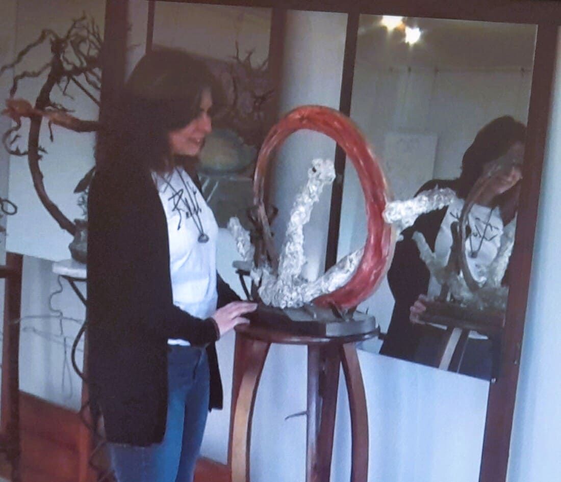Nuria artist from Reluet in her studio next to one of her works